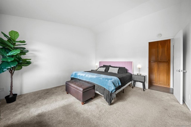 bedroom featuring carpet flooring and vaulted ceiling