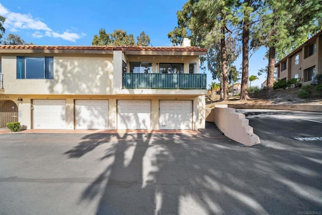 view of front of house featuring a garage and a balcony