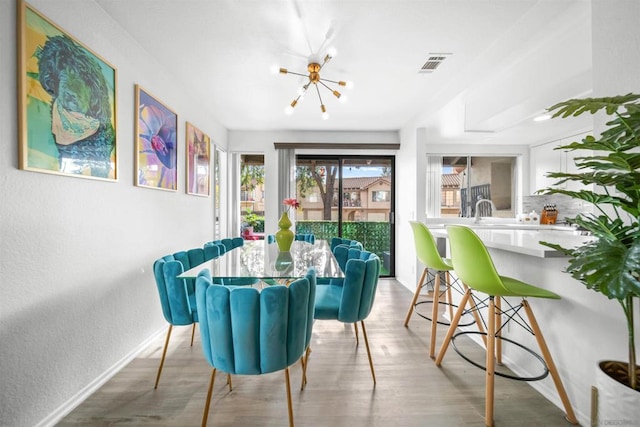 dining room featuring a chandelier and light hardwood / wood-style floors