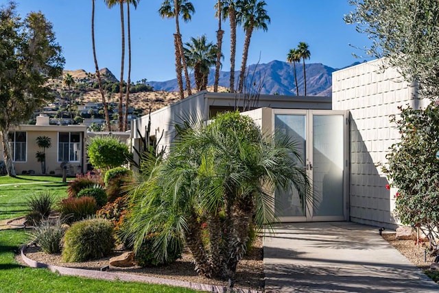 exterior space with a mountain view and a front yard