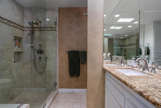 bathroom with vanity, tile patterned floors, and walk in shower