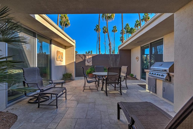 view of patio featuring area for grilling and a grill