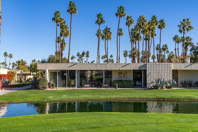 exterior space with a water view and a yard