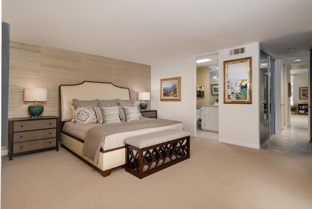 carpeted bedroom with connected bathroom