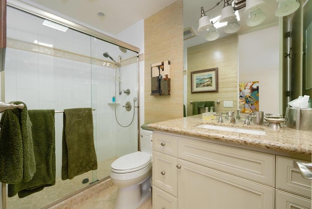 bathroom featuring an enclosed shower, vanity, tile patterned floors, and toilet