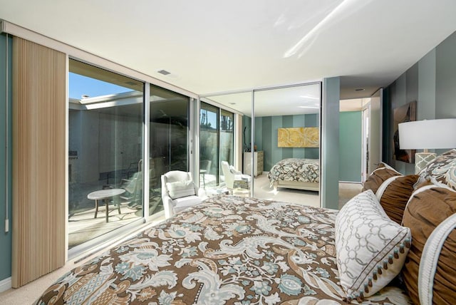 carpeted bedroom with access to exterior and expansive windows