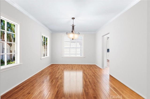 interior space with hardwood / wood-style flooring, a wealth of natural light, and ornamental molding