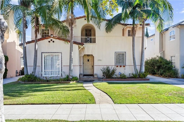 mediterranean / spanish house with a front lawn