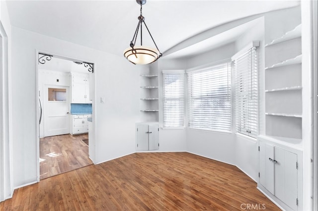 unfurnished dining area featuring hardwood / wood-style floors