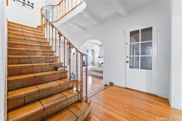 foyer entrance featuring beam ceiling and light wood-type flooring