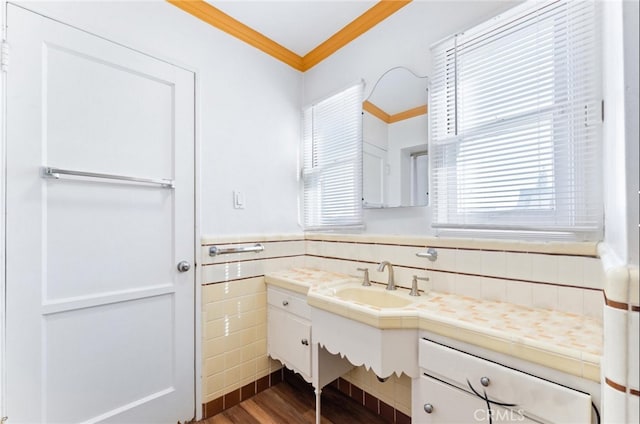 bathroom featuring crown molding, vanity, tile walls, and hardwood / wood-style flooring