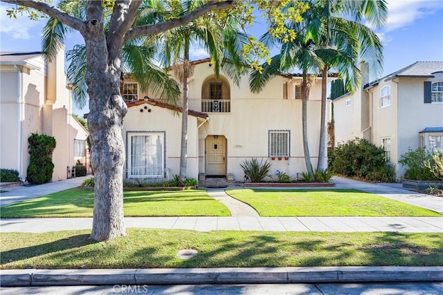 mediterranean / spanish-style home featuring a front yard