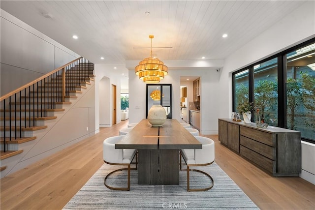 dining room with wooden ceiling and light wood-type flooring