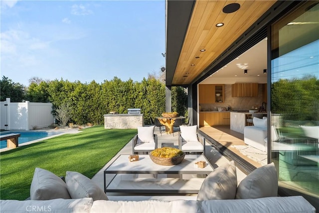 view of patio / terrace featuring an outdoor hangout area and an outdoor kitchen