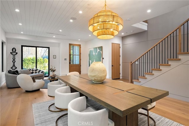 dining room with light hardwood / wood-style flooring and wooden ceiling