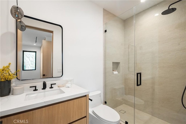 bathroom with vanity, toilet, and an enclosed shower