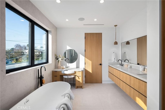 bathroom featuring vanity, a bath, and tile patterned flooring