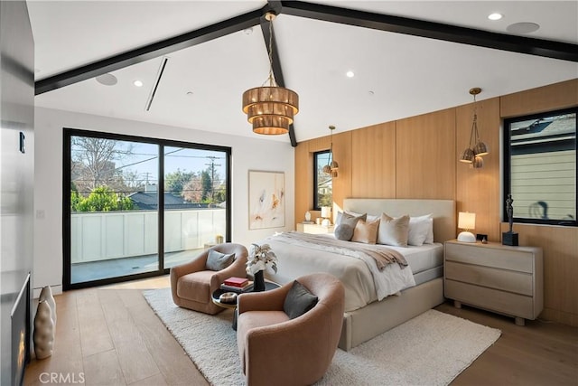 bedroom featuring vaulted ceiling with beams, access to outside, and wooden walls