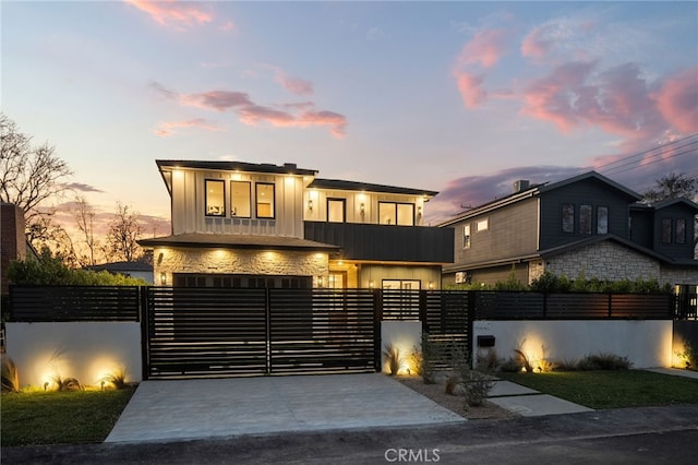 contemporary house with a garage and a balcony