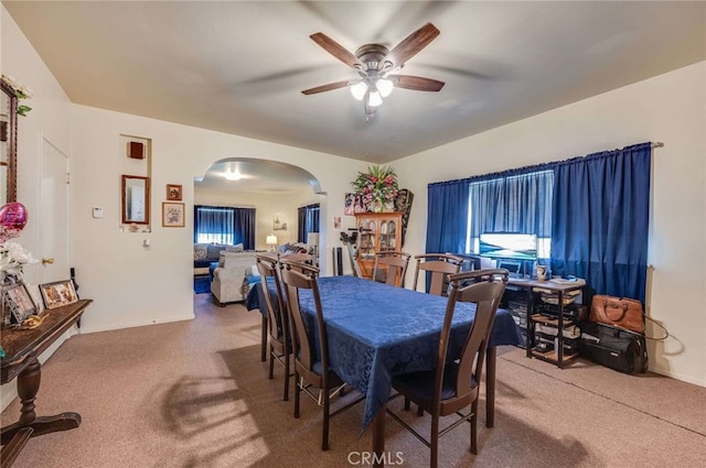 carpeted dining area featuring ceiling fan