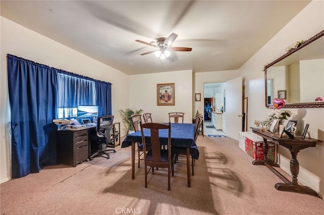 dining room featuring light carpet and ceiling fan