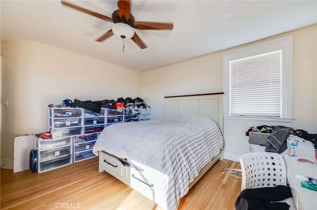 bedroom with ceiling fan and light wood-type flooring