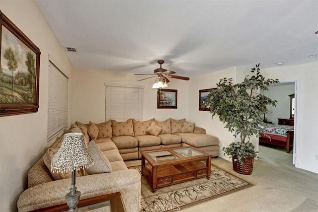 carpeted living room featuring ceiling fan