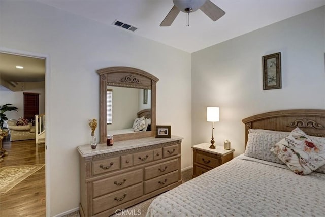 bedroom with light hardwood / wood-style floors and ceiling fan