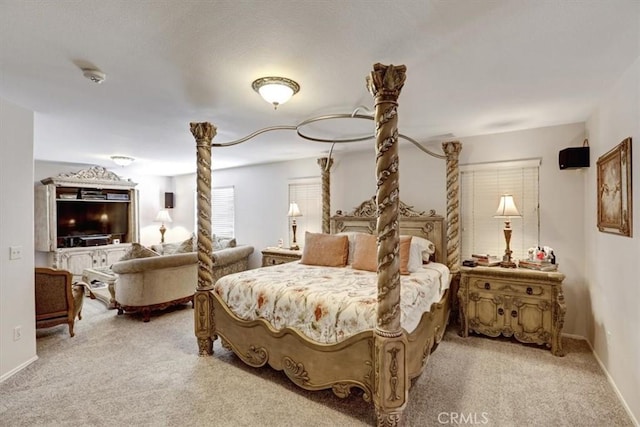 carpeted bedroom with ornate columns