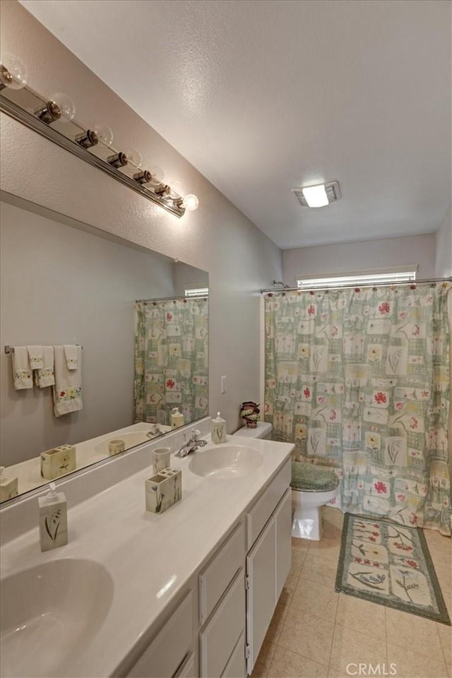 bathroom with tile patterned floors, toilet, and vanity