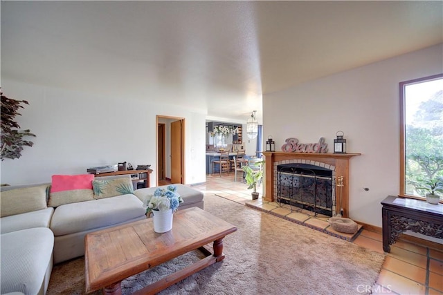 living room with tile patterned flooring and a tile fireplace