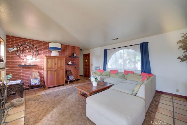 living room with brick wall and light tile patterned floors