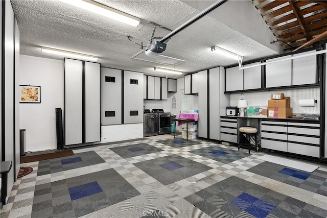 garage featuring a garage door opener and separate washer and dryer