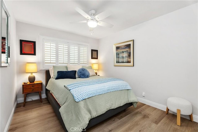 bedroom with light hardwood / wood-style floors and ceiling fan