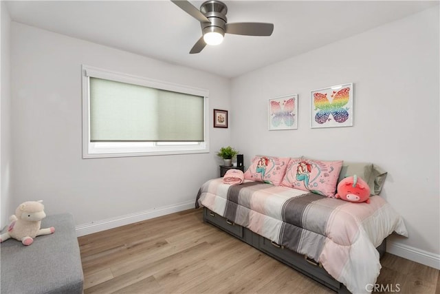 bedroom with light hardwood / wood-style flooring and ceiling fan