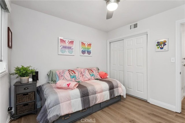 bedroom featuring light hardwood / wood-style floors, a closet, and ceiling fan