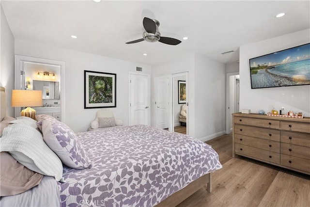 bedroom with ensuite bath, light hardwood / wood-style flooring, and ceiling fan