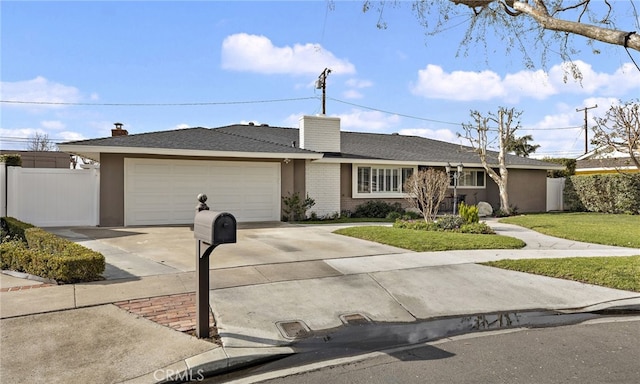 ranch-style home featuring a garage and a front yard