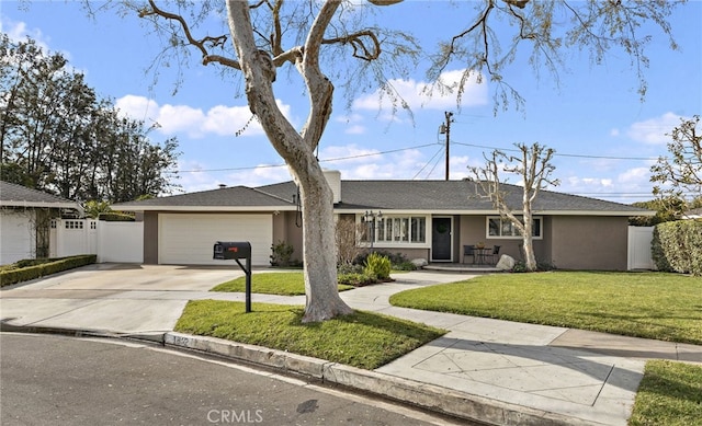 ranch-style house featuring a garage and a front yard