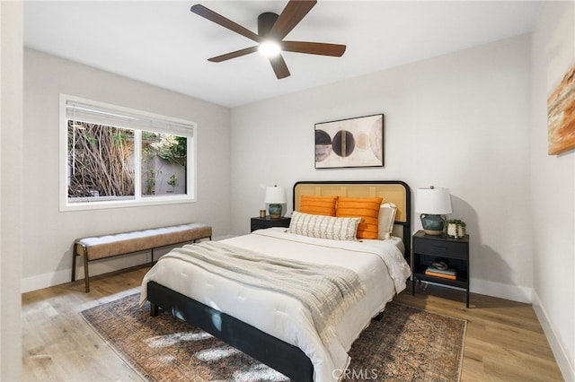 bedroom with ceiling fan and light wood-type flooring