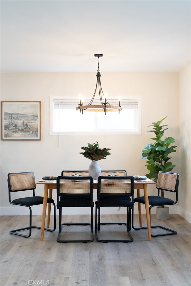 dining space featuring a chandelier and light wood-type flooring