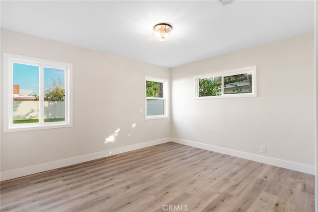 spare room with light hardwood / wood-style floors