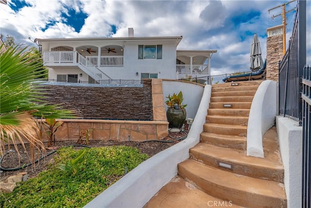 exterior space featuring ceiling fan