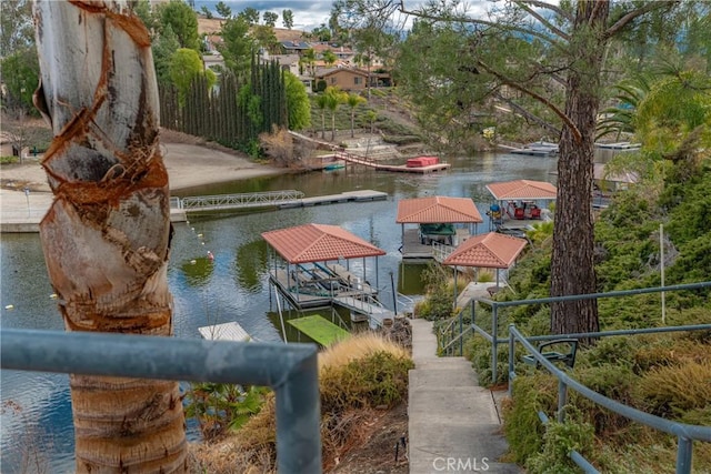 view of dock with a gazebo and a water view