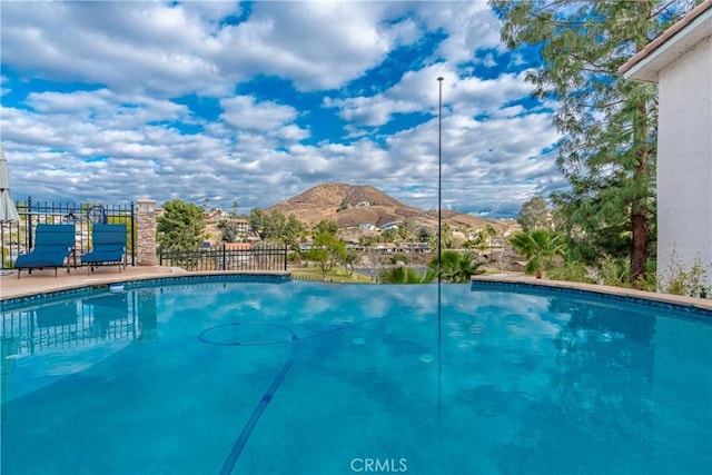 view of swimming pool featuring a mountain view