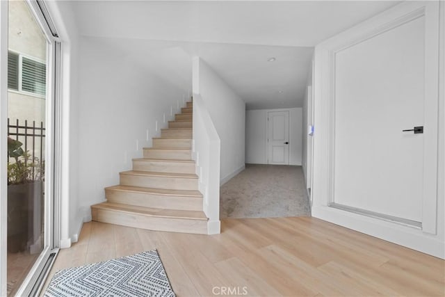 stairs with wood-type flooring