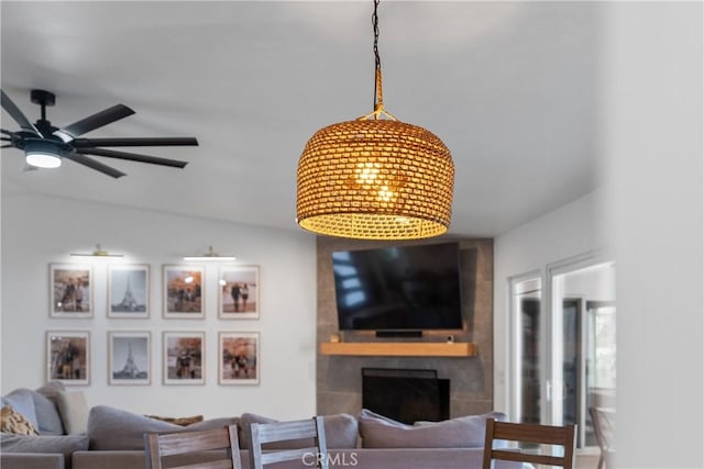 living room with vaulted ceiling, a large fireplace, and ceiling fan