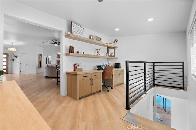 interior space with ceiling fan and light hardwood / wood-style floors