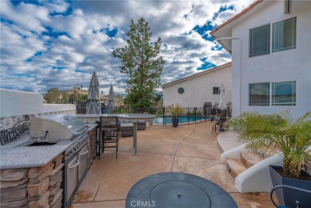 view of patio with area for grilling and a grill