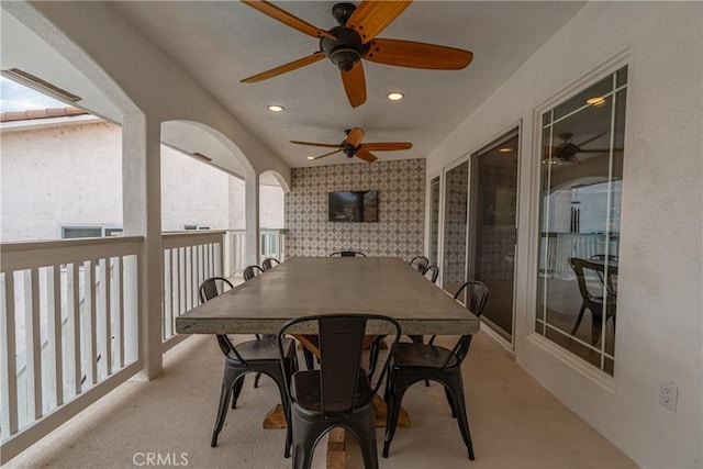 exterior space with a balcony and ceiling fan